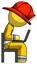 Yellow Firefighter Fireman Man using laptop computer while sitting in chair view from side