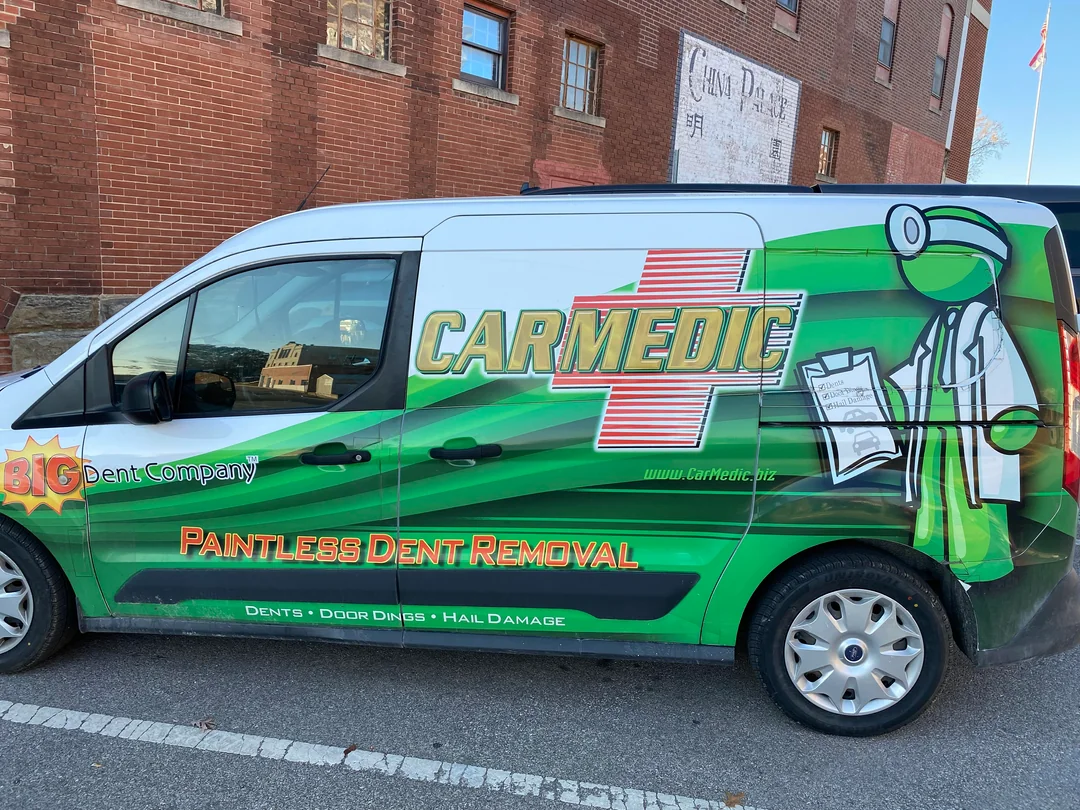 Green stick-figure mascot on CarMedic van in Kirksville, MO. Green man used as splash graphic on van…