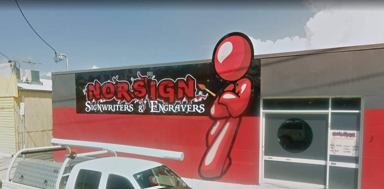 Large red 3D figure leaning on Norsign logo in West Mackay, Queensland.