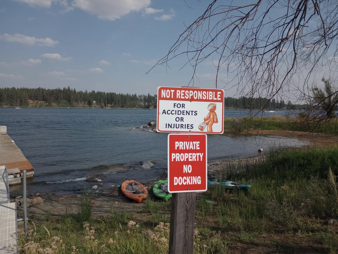Orange Man on safety sign by lake